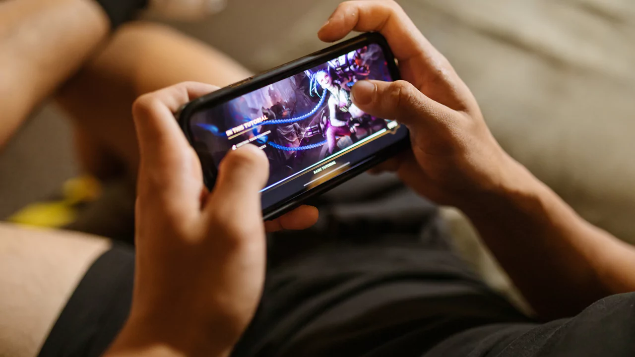 a person holding a phone and playing a game on it.